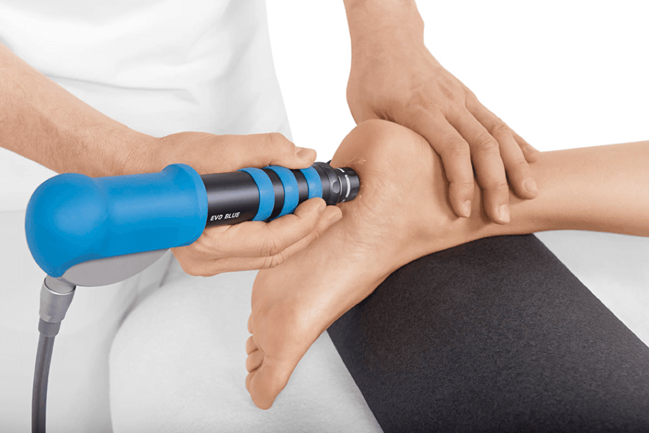 Therapist applying pressure to the sole of a foot during a reflexology session